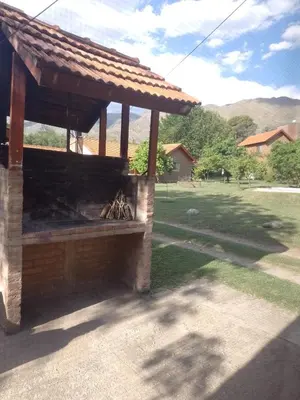 a outdoor grill with a roof on a yard at Cabañas Nicasio in Merlo