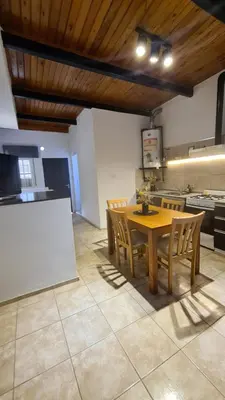 a dining room with a table and chairs in a kitchen at LitStay Paso de los Andes PA in Cordoba