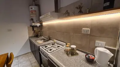 a small kitchen with a stove and a sink at LitStay Paso de los Andes PA in Cordoba