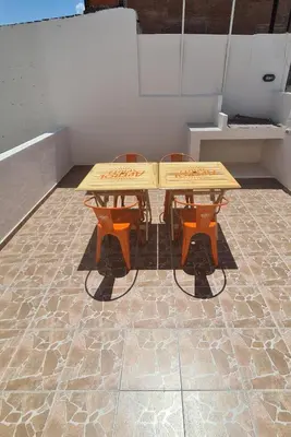 a wooden table and two chairs in a room at LitStay Paso de los Andes PA in Cordoba