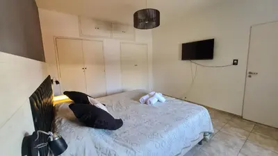 a bedroom with a bed with a teddy bear on it at LitStay Paso de los Andes PA in Cordoba