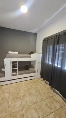 a room with two bunk beds and a black curtain at LitStay Paso de los Andes PA in Cordoba