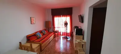 a living room with a couch and a window at Departamento pleno centro de Villa Carlos Paz in Villa Carlos Paz