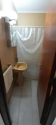 a bathroom with a sink and a shower curtain at Departamento pleno centro de Villa Carlos Paz in Villa Carlos Paz