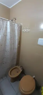 a bathroom with a toilet and a sink at Departamento pleno centro de Villa Carlos Paz in Villa Carlos Paz