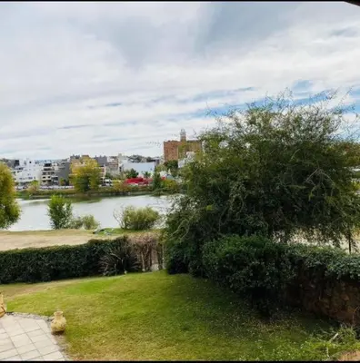 a view of a body of water with a tree at Departamento pleno centro de Villa Carlos Paz in Villa Carlos Paz