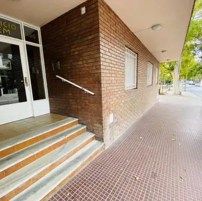 a brick building with stairs next to a door at Departamento pleno centro de Villa Carlos Paz in Villa Carlos Paz