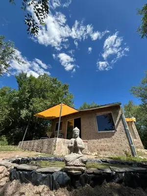 a statue in front of a building with a house at Sacha Manta in Mina Clavero