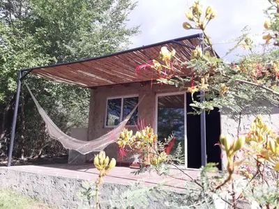 a tent with a hammock in front of it at Sacha Manta in Mina Clavero