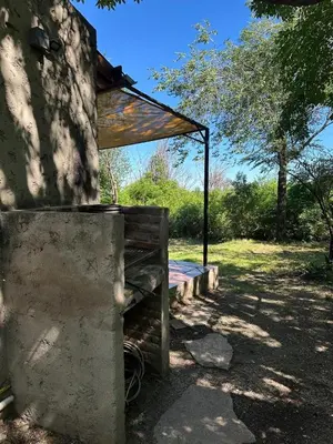 a building with a shelter on the side of it at Sacha Manta in Mina Clavero