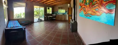 a room with a tile floor and a painting on the wall at Sacha Manta in Mina Clavero