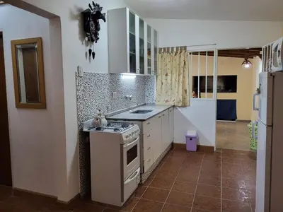 a kitchen with a stove and a sink in it at Otto's Haus in Villa General Belgrano