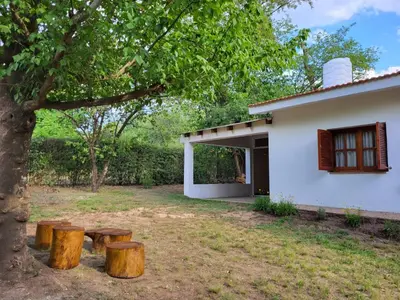 a group of logs sitting next to a house at Otto's Haus in Villa General Belgrano
