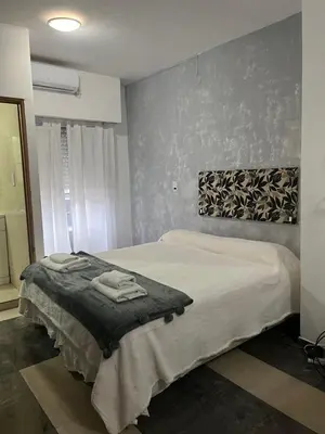 a bedroom with a large bed in a room at DERC Temporarios in Río Cuarto
