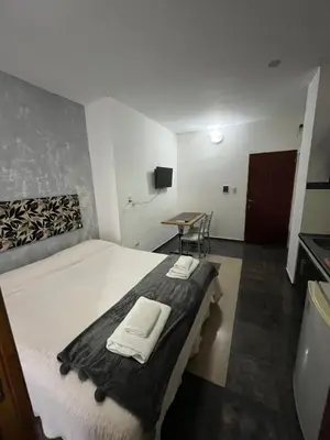 a bedroom with a bed with two towels on it at DERC Temporarios in Río Cuarto