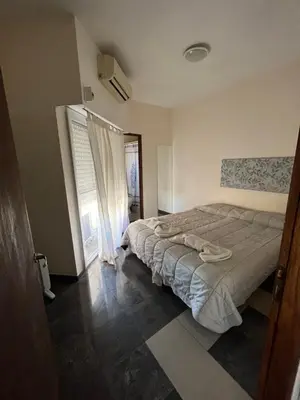 a bedroom with a bed and a window at DERC Temporarios in Río Cuarto
