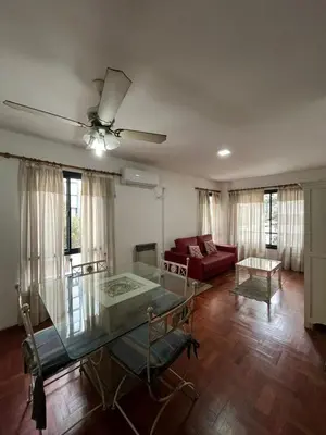 a living room with a glass table and a couch at Montevideo 20 Bis in Cordoba