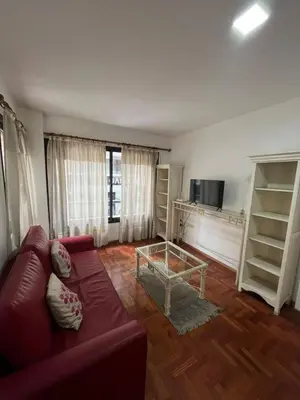 a living room with a red couch and a table at Montevideo 20 Bis in Cordoba