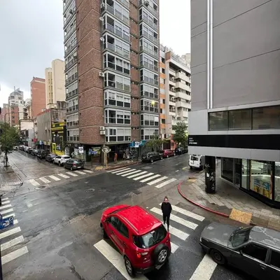 a red van parked on a street in a city at Montevideo 20 Bis in Cordoba