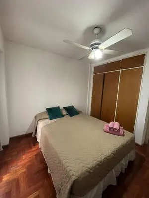 a bedroom with a bed with a ceiling fan at Montevideo 20 Bis in Cordoba