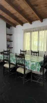 a room with a table and two benches and a window at Chalet exclusivo en Tanti, Córdoba in Tanti
