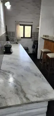 a kitchen with a large concrete counter in a room at Chalet exclusivo en Tanti, Córdoba in Tanti