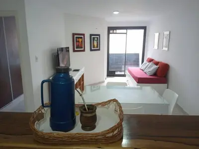 a blue water bottle on a table in a living room at Tranquilidad, privacidad y relax in Cordoba