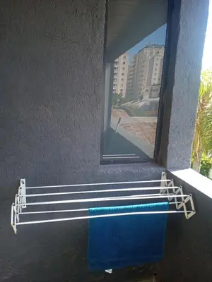 a bathroom with a window and blue towels at Tranquilidad, privacidad y relax in Cordoba