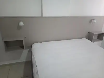 a bedroom with a white bed and white cabinets at Tranquilidad, privacidad y relax in Cordoba