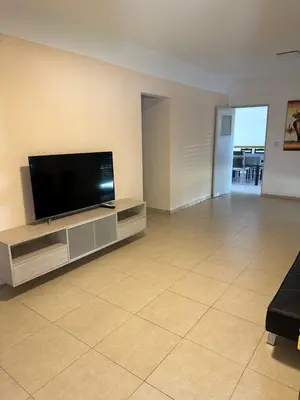 a living room with a flat screen tv on a entertainment center at Casa Villa CARLOS PAZ CERCA DE COSTANERA in Villa Carlos Paz