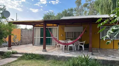 a patio with a hammock in front of a house at Gratitud! in Almafuerte
