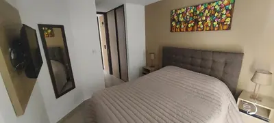 a bedroom with a bed and a painting on the wall at Centro Carlos Paz 1 dormitorio in Villa Carlos Paz