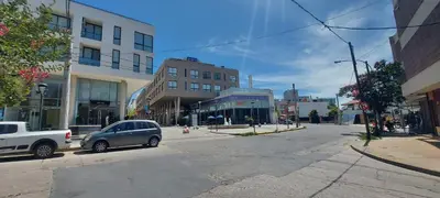 a small car parked on a city street with buildings at Centro Carlos Paz 1 dormitorio in Villa Carlos Paz