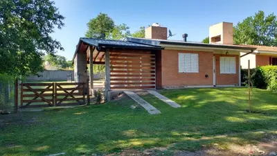 a small house with a fence and a gate at La casa de Mayú in San Antonio de Arredondo