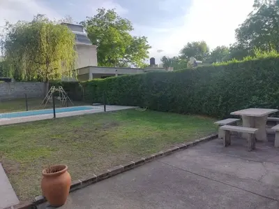 a park with a bench and a table and a fence at La casa de Mayú in San Antonio de Arredondo