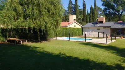 a yard with a pool and a house with a tree at La casa de Mayú in San Antonio de Arredondo