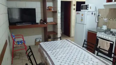 a kitchen with a table and a refrigerator and a stove at La casa de Mayú in San Antonio de Arredondo