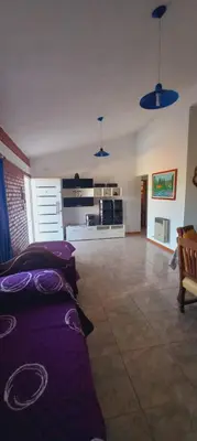 a living room with purple pillows on a couch at La Estancita de Tanti con pileta in Tanti
