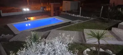 a swimming pool in the middle of a yard at night at La Estancita de Tanti con pileta in Tanti