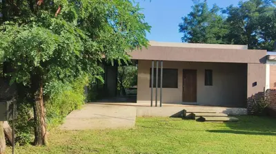 a small house with a tree in front of it at Casa Moderna in Mina Clavero