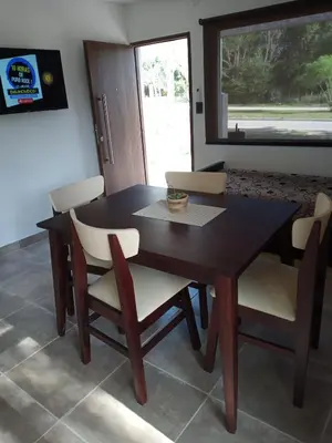 a dining room table and chairs with a window at Casa Moderna in Mina Clavero