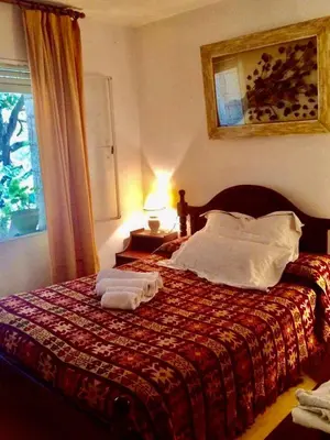 a bedroom with a bed with towels on it at Departamento Pama in Santa Rosa de Calamuchita