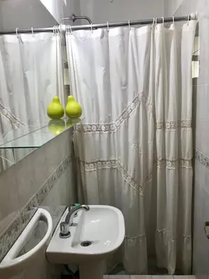 a bathroom with a sink and a shower curtain at Departamento Pama in Santa Rosa de Calamuchita
