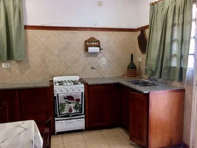 a kitchen with a stove and a sink at Departamento Pama in Santa Rosa de Calamuchita