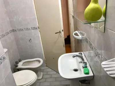 a bathroom with a white sink and a toilet at Departamento Pama in Santa Rosa de Calamuchita
