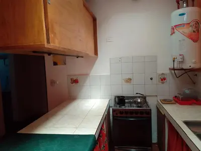 a kitchen with a stove and a counter top at La Casa de la Parra in Villa Carlos Paz