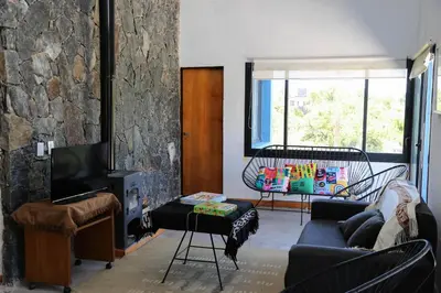 a living room with a couch and a tv at Casa Relax Potrero de Garay in Potrero de Garay