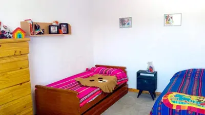 a bedroom with a bed with a bear blanket at Casa Relax Potrero de Garay in Potrero de Garay