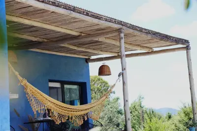 a hammock hanging off the side of a house at Casa Relax Potrero de Garay in Potrero de Garay