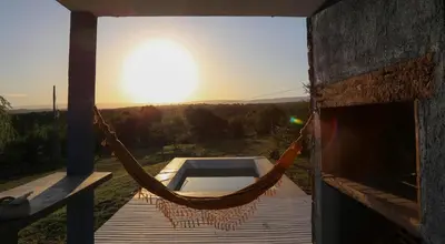a hammock on a building with the sunset in the background at Casa Relax Potrero de Garay in Potrero de Garay